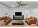 Cozy living room with hardwood floors, ceiling fan and comfortable leather furniture, perfect for entertaining guests at 19204 Briarbrook Dr, Tampa, FL 33647