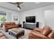 Cozy living room with hardwood floors, ceiling fan and comfortable leather furniture, perfect for entertaining guests at 19204 Briarbrook Dr, Tampa, FL 33647