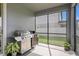 Outdoor kitchen with stainless grill and lots of prep space on screened patio at 19204 Briarbrook Dr, Tampa, FL 33647
