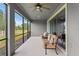Relaxing screened patio features neutral seating, ceiling fan and views of the spacious backyard at 19204 Briarbrook Dr, Tampa, FL 33647