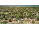 Scenic aerial view of homes surrounded by lush greenery and water in the distance at 1974 N Betty Ln, Clearwater, FL 33755