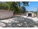Spacious backyard area covered in decorative white stone with two storage sheds at 1974 N Betty Ln, Clearwater, FL 33755