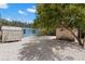 Large backyard featuring white decorative stone, two sheds, and plenty of natural shade at 1974 N Betty Ln, Clearwater, FL 33755