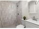 Modern bathroom featuring stylish tiled shower, sleek vanity, and contemporary fixtures at 1974 N Betty Ln, Clearwater, FL 33755