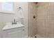 Modern bathroom featuring a shower with stylish vertical tiles and a white vanity at 1974 N Betty Ln, Clearwater, FL 33755