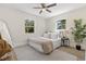 Cozy bedroom featuring neutral tones, natural light from two windows, and ceiling fan at 1974 N Betty Ln, Clearwater, FL 33755