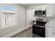 Kitchen with stainless steel oven, white cabinets, and plenty of natural light at 1974 N Betty Ln, Clearwater, FL 33755