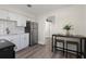Clean kitchen featuring white cabinets, modern appliances, and stainless steel refrigerator at 1974 N Betty Ln, Clearwater, FL 33755