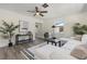Comfortable living room with a white sectional, modern decor, and a ceiling fan at 1974 N Betty Ln, Clearwater, FL 33755