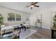 Comfortable living room featuring modern decor, a white sectional sofa, and hardwood floors at 1974 N Betty Ln, Clearwater, FL 33755