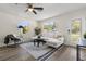 Bright living room with a comfortable white sectional sofa, stylish rug, and lots of natural light at 1974 N Betty Ln, Clearwater, FL 33755