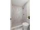 Nicely remodeled shower featuring stylish vertical tile and modern shower head at 1974 N Betty Ln, Clearwater, FL 33755