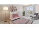 Cozy Bedroom with a white crib, rocking chair, and decorative shelving at 2250 Rikkola Ln, Wesley Chapel, FL 33543