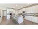 Spacious kitchen features an island with seating, stainless steel appliances, and white cabinetry at 2250 Rikkola Ln, Wesley Chapel, FL 33543