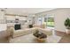 Inviting living room with a large sectional sofa, modern coffee table, and sliding doors to the backyard at 2250 Rikkola Ln, Wesley Chapel, FL 33543