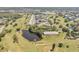 Aerial view overlooking community apartments, golf course and winding lake on a sunny day at 2310 Denmark St # 30, Clearwater, FL 33763