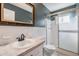 Modern bathroom with framed mirror, marble counter, and glass shower door at 2310 Denmark St # 30, Clearwater, FL 33763