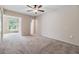 Spacious bedroom with a ceiling fan and natural light from the attached sunroom at 2310 Denmark St # 30, Clearwater, FL 33763