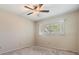 Bedroom featuring a ceiling fan, carpet, and a window at 2310 Denmark St # 30, Clearwater, FL 33763