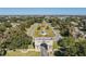 Aerial view of a community entrance with a large globe, mature trees, and manicured lawns, showcasing the welcoming ambiance at 2310 Denmark St # 30, Clearwater, FL 33763