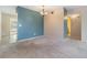 Minimalist dining area with blue accent wall, neutral carpet, and simple chandelier for a cozy ambiance at 2310 Denmark St # 30, Clearwater, FL 33763