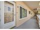 Exterior entrance showcasing door number 30, a window, and an outdoor hallway lined with units at 2310 Denmark St # 30, Clearwater, FL 33763
