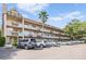 View of the community building featuring unique balcony railings and conveniently located parking spaces at 2310 Denmark St # 30, Clearwater, FL 33763