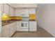 Cozy kitchen with white appliances and cabinets with tile flooring at 2310 Denmark St # 30, Clearwater, FL 33763