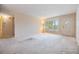 An open-concept living room with large window and a doorway leading into another room at 2310 Denmark St # 30, Clearwater, FL 33763