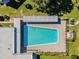 Aerial view of the geometric pool surrounded by lounge chairs, with shade provided by metal awning at 2310 Denmark St # 30, Clearwater, FL 33763