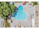 Unique aerial view of a community pool with ample lounge space and mature trees that provide shade for relaxation at 2310 Denmark St # 30, Clearwater, FL 33763