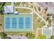 Aerial view of well-maintained tennis courts with adjacent shuffleboard courts and meticulous landscaping for recreational enjoyment at 2310 Denmark St # 30, Clearwater, FL 33763