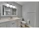 Bathroom featuring a white vanity with drawers, a large mirror, and a toilet at 2313 Grenoble Pl # 2313, Sun City Center, FL 33573