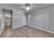 Bedroom with wood-look floors, ceiling fan, closet, and an ensuite bathroom featuring a white vanity at 2313 Grenoble Pl # 2313, Sun City Center, FL 33573