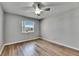 Light, airy bedroom featuring wood-look flooring, a ceiling fan, and a bright window at 2313 Grenoble Pl # 2313, Sun City Center, FL 33573