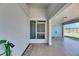 Covered entryway highlighting a secure screen door and access to the carport at 2313 Grenoble Pl # 2313, Sun City Center, FL 33573