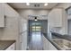 Open concept kitchen with stainless steel appliances and dark countertops leads to outdoor living area at 2313 Grenoble Pl # 2313, Sun City Center, FL 33573