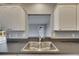 Bright kitchen with dark countertops and view into another room at 2313 Grenoble Pl # 2313, Sun City Center, FL 33573