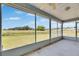 Screened lanai providing expansive view of the lush green backyard and pond at 2313 Grenoble Pl # 2313, Sun City Center, FL 33573
