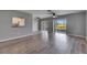 Bright living room featuring hardwood floors, a ceiling fan, and sliding glass doors to the outdoor space at 2313 Grenoble Pl # 2313, Sun City Center, FL 33573