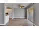 Open-plan living room with hardwood floors and access to the outdoors via sliding glass doors at 2313 Grenoble Pl # 2313, Sun City Center, FL 33573