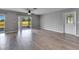 Relaxing living space with access to screened patio via sliding doors, features sleek hardwood floors at 2313 Grenoble Pl # 2313, Sun City Center, FL 33573