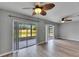 Sunlit living area features hardwood floors, ceiling fans, and sliding glass doors for scenic views and fresh air at 2313 Grenoble Pl # 2313, Sun City Center, FL 33573