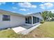 View of the screened patio of this home with white gravel, neutral tones and access to the backyard at 2313 Grenoble Pl # 2313, Sun City Center, FL 33573