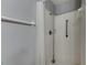 Shower with white tile, shower curtain, and handrails at 2313 Grenoble Pl # 2313, Sun City Center, FL 33573