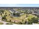 Expansive aerial view showcasing a community with lush golf course and serene pond at 2458 Columbia Dr E # 84, Clearwater, FL 33763