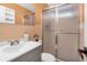 This bathroom features a tiled shower with glass doors, large mirror, and vanity with great lighting at 2458 Columbia Dr E # 84, Clearwater, FL 33763