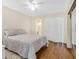 This bedroom features wood floors, neutral walls, neutral color bed set, a ceiling fan, and closet space at 2458 Columbia Dr E # 84, Clearwater, FL 33763