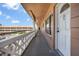 Inviting hallway with balcony overlooking building's landscaped exterior and parking at 2458 Columbia Dr E # 84, Clearwater, FL 33763