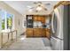 Bright kitchen featuring tile floors, natural wood cabinets and modern appliances at 2458 Columbia Dr E # 84, Clearwater, FL 33763